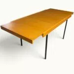 Table à manger extensible ARP Guariche Mortier Motte éditée par Minvielle vers 1960 plaqué frêne piètement métal laqué noir