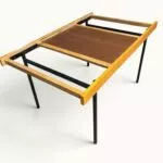 Table à manger extensible ARP Guariche Mortier Motte éditée par Minvielle vers 1960 plaqué frêne piètement métal laqué noir